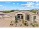 Desert-landscaped home featuring a spacious three-car garage and prominent front entrance at 11448 E Blue Sky Dr, Scottsdale, AZ 85262