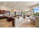 Open-concept kitchen boasts granite countertops, tile floors, and seamless transition to the dining and living areas at 11448 E Blue Sky Dr, Scottsdale, AZ 85262