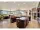 Expansive kitchen with granite countertops, custom cabinets, center island, and easy access to the inviting living space at 11448 E Blue Sky Dr, Scottsdale, AZ 85262