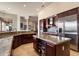 Well-appointed kitchen features granite countertops, stainless steel appliances, custom cabinetry, and a functional center island at 11448 E Blue Sky Dr, Scottsdale, AZ 85262
