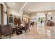 Spacious living room featuring tile flooring, decorative columns, and a well-lit dining area at 11448 E Blue Sky Dr, Scottsdale, AZ 85262
