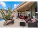 Expansive patio with seating areas, a fire pit and lush desert landscaping for relaxation at 11448 E Blue Sky Dr, Scottsdale, AZ 85262