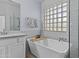 Bright bathroom featuring a soaking tub and elegant fixtures providing a spa-like experience at 119 S Monterey St, Gilbert, AZ 85233