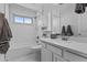 This bathroom has a subway tile shower, tile floors, and a white vanity at 119 S Monterey St, Gilbert, AZ 85233