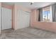 This bedroom has plush carpet, a window, and a sliding door closet at 119 S Monterey St, Gilbert, AZ 85233