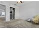This bedroom has plush carpet, closet organizer, and a chair at 119 S Monterey St, Gilbert, AZ 85233