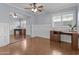 Inviting bedroom featuring hardwood floors, built-in desk, and a mirrored closet at 119 S Monterey St, Gilbert, AZ 85233