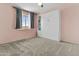 This bedroom has plush carpet, built in shelves, and a window at 119 S Monterey St, Gilbert, AZ 85233
