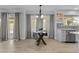 Bright dining area with modern table, chandelier lighting, and backyard view with sliding glass doors at 119 S Monterey St, Gilbert, AZ 85233