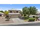 Two-story home with a two car garage, manicured lawn, and desert landscaping at 119 S Monterey St, Gilbert, AZ 85233