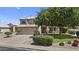 Two-story home with a two car garage, manicured lawn, and desert landscaping at 119 S Monterey St, Gilbert, AZ 85233