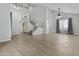 Spacious living room with wood look tile flooring and staircase at 119 S Monterey St, Gilbert, AZ 85233