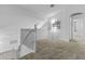 Open loft area with neutral carpet, white walls, and natural light provides a versatile space at 119 S Monterey St, Gilbert, AZ 85233