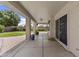 Covered patio with ceiling fan, concrete flooring, and sliding glass doors leading to the home's interior at 119 S Monterey St, Gilbert, AZ 85233