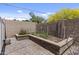 Beautiful backyard planter with stone retaining wall and brick paver patio, perfect for gardening and outdoor enjoyment at 119 S Monterey St, Gilbert, AZ 85233