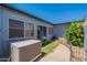 Backyard with an air conditioning unit, decorative metal fence, and flowering bushes at 13261 N 110Th Ave, Sun City, AZ 85351