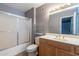 Bathroom featuring a shower over tub, a vanity and a large mirror at 13261 N 110Th Ave, Sun City, AZ 85351