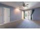 Large bedroom with neutral carpeting, closet and access to the enclosed patio at 13261 N 110Th Ave, Sun City, AZ 85351