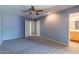 Bedroom with new carpeting, ceiling fan, two closets, and an ensuite bathroom at 13261 N 110Th Ave, Sun City, AZ 85351