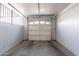 This is an empty single car garage with a white door and concrete floor at 13261 N 110Th Ave, Sun City, AZ 85351