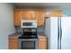 Kitchen with wood cabinetry, stainless steel appliances and countertops at 13261 N 110Th Ave, Sun City, AZ 85351