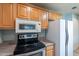 Kitchen with wood cabinetry, stainless steel appliances and countertops at 13261 N 110Th Ave, Sun City, AZ 85351