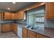 Kitchen featuring wood cabinets, stainless steel sink and countertops at 13261 N 110Th Ave, Sun City, AZ 85351