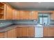 Functional kitchen featuring wood cabinetry, and stainless steel sink beneath a window at 13261 N 110Th Ave, Sun City, AZ 85351