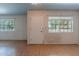 Open-concept living room featuring laminate flooring and natural light at 13261 N 110Th Ave, Sun City, AZ 85351