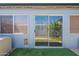 Sliding glass doors lead to the outside patio surrounded by a small grass area and flowering bushes at 13261 N 110Th Ave, Sun City, AZ 85351