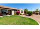 Backyard featuring a manicured lawn, mature landscaping, patio furniture and a privacy fence at 14921 W Luna S Dr, Litchfield Park, AZ 85340