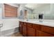 Well-lit bathroom features double sinks, a soaking tub, and a glass-enclosed shower at 14921 W Luna S Dr, Litchfield Park, AZ 85340