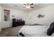 Spacious primary bedroom features a ceiling fan, carpet flooring, and ample natural light at 14921 W Luna S Dr, Litchfield Park, AZ 85340