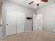 Bright bedroom with carpet flooring, a ceiling fan, and closet with sliding doors at 14921 W Luna S Dr, Litchfield Park, AZ 85340