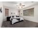 Calm bedroom with modern fan, neutral colors, and soft carpet for a peaceful retreat at 14921 W Luna S Dr, Litchfield Park, AZ 85340