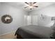 Well-appointed bedroom featuring carpet flooring, a ceiling fan, and decorative artwork at 14921 W Luna S Dr, Litchfield Park, AZ 85340