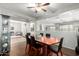 Dining room showcasing hardwood floors, modern furniture, a large mirror, and views to other living spaces at 14921 W Luna S Dr, Litchfield Park, AZ 85340