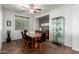 Dining room features hardwood floors, black modern chairs, large window, and modern display case at 14921 W Luna S Dr, Litchfield Park, AZ 85340