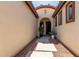 Charming front entry showcasing a walkway and a decorative security door at 14921 W Luna S Dr, Litchfield Park, AZ 85340
