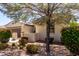 Charming single-story home showcasing mature landscaping with colorful bushes, and an attached two-car garage at 14921 W Luna S Dr, Litchfield Park, AZ 85340