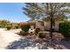 Beautiful single-story home featuring manicured landscaping with colorful shrubs and an attached two-car garage at 14921 W Luna S Dr, Litchfield Park, AZ 85340