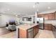 Open kitchen with a granite island and stainless steel appliances overlooking the living room at 14921 W Luna S Dr, Litchfield Park, AZ 85340