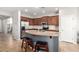 Modern kitchen featuring an island with granite countertops, stainless steel appliances, and ample cabinet space at 14921 W Luna S Dr, Litchfield Park, AZ 85340