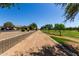 Well-maintained walking trail with green space and trees, offering residents a safe and enjoyable route for outdoor exercise at 14921 W Luna S Dr, Litchfield Park, AZ 85340
