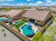 High angle of a luxurious backyard showcasing a pool, lounging area, covered patio, and beautiful desert landscaping at 15663 S 183Rd Dr, Goodyear, AZ 85338