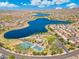 This aerial view showcases a picturesque lake community with lush landscaping and resort-style amenities at 15663 S 183Rd Dr, Goodyear, AZ 85338