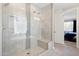 A modern tiled shower with a glass door, seating and lights is featured in this bright bathroom at 15663 S 183Rd Dr, Goodyear, AZ 85338