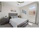 Cozy bedroom featuring a wood frame bed, decorative pillows and matching bedside tables at 15663 S 183Rd Dr, Goodyear, AZ 85338