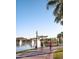 Scenic community walking path with lush landscaping, lake views, and water features at 15663 S 183Rd Dr, Goodyear, AZ 85338