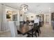 Inviting dining room featuring a dark wood table, stylish lighting, and views into the open concept living area at 15663 S 183Rd Dr, Goodyear, AZ 85338